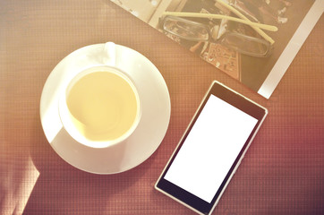 Fototapeta na wymiar hot tea drinking and using smartphone