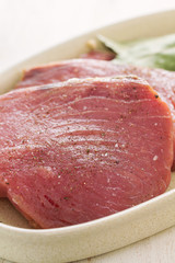 raw tuna on dish on white background