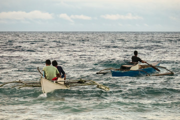 Fishermen Paddling Through a Rough Sea