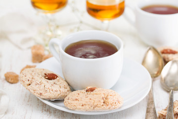a cup of coffee with almond cookies