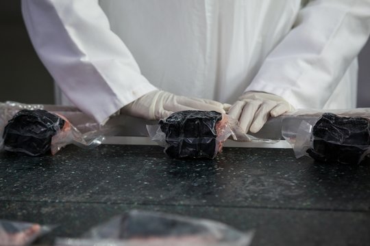 Butcher packing raw meat