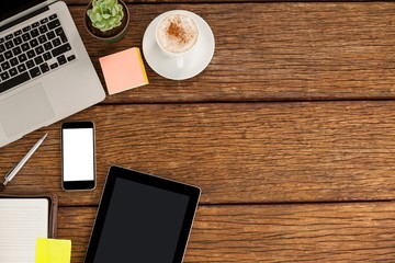 Laptop, smartphone and digital tablet with cup of coffee 