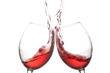 Two red wine glasses and splashing action on white background. Cheer celebration concept photo. Macro view photo.
