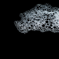 Soap foam suds and shower bubbles. Macro view. Black background. copy space