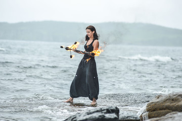 play with fire show on the shore of the sea