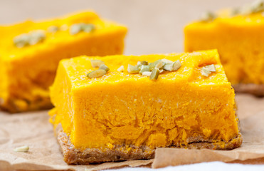 Slices of raw vegan pumpkin cheesecake. Love for a healthy raw desserts concept.