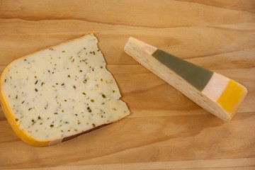 Slice of dutch gouda cheese on chopping board
