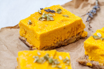 Slices of raw vegan pumpkin cheesecake. Love for a healthy raw desserts concept.