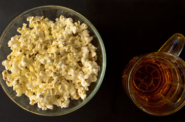 salty popcorn and a mug of beer