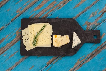 Cheese with rosemary on chopping board
