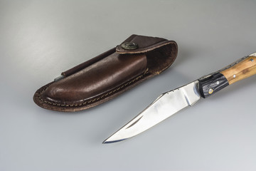 Folding knife with leather travel pouch and sharpener