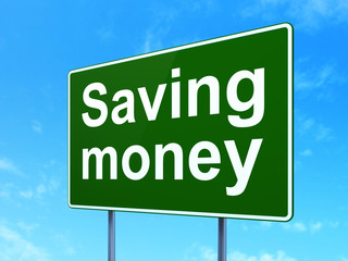 Business concept: Saving Money on road sign background