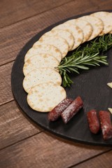 Biscuit, rosemary and sausages on slate board