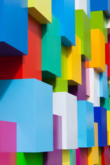 Abstract colorful architectural objects. Violet blue red green white yellow blocks with different colors variation. Vertical photo. Geometric shapes