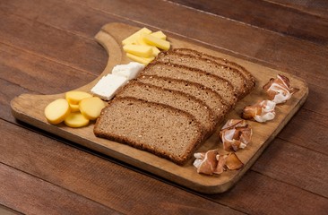 Slices of brown bread and variety of cheese
