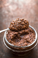 Spoon with raw swollen flax seeds vertical