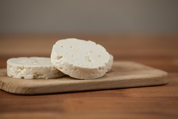 Slices of cheese on chopping board