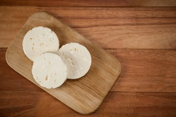 Slices of cheese on chopping board