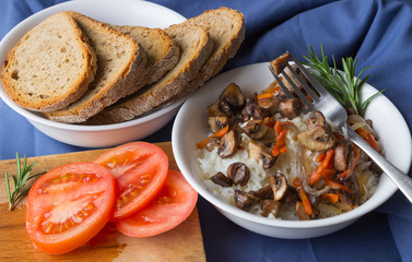 Classic Risotto with mushrooms and vegetables served on a white  plate.
