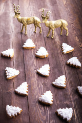 Ginger cookies in the shape of a Christmas tree on  wooden back