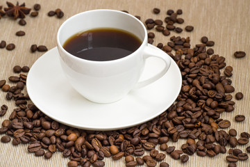 Coffee cup and coffee beans on table