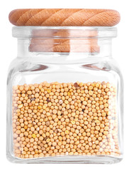 Grains of mustard in a glass bottle. Isolated on white backgroun