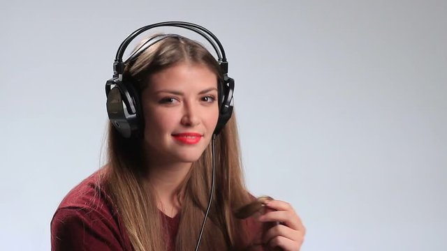 Provocative young brunette posing with headphones