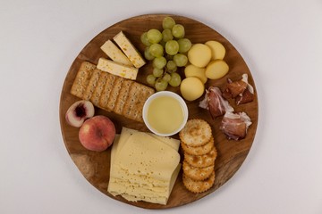 Different types of cheese, biscuits, fruits, sauce