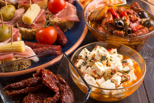 Mediterranean snacks on wooden table - tapas