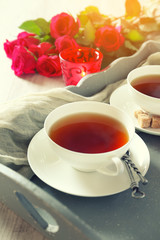 Romantic morning tea for two with candles and red roses