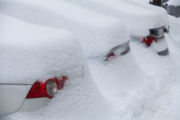 Row of snow-covered cars