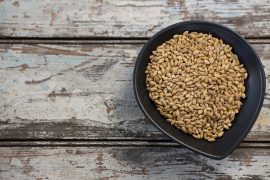 Wheat grains in black bowl