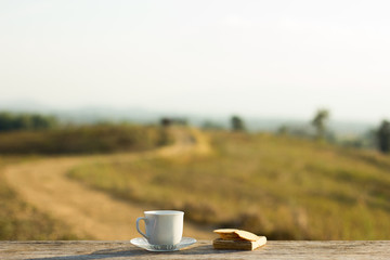 Coffee with snacks meadows as a backdrop, Place the camera with