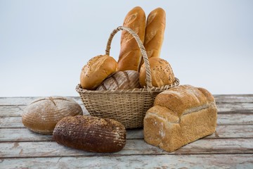 Various bread loaves on wooden surface