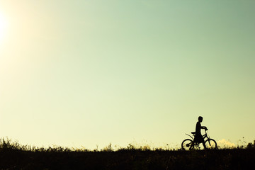 Obraz premium Silhouette of children cyclist riding Movement on the background