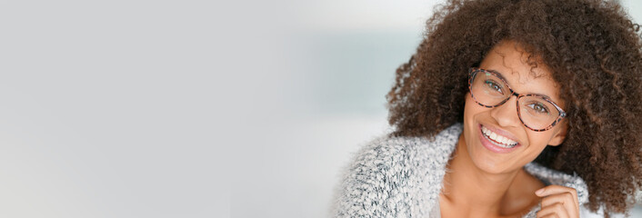 Portrait of attractive and cheerful mixed-race woman with eyeglasses