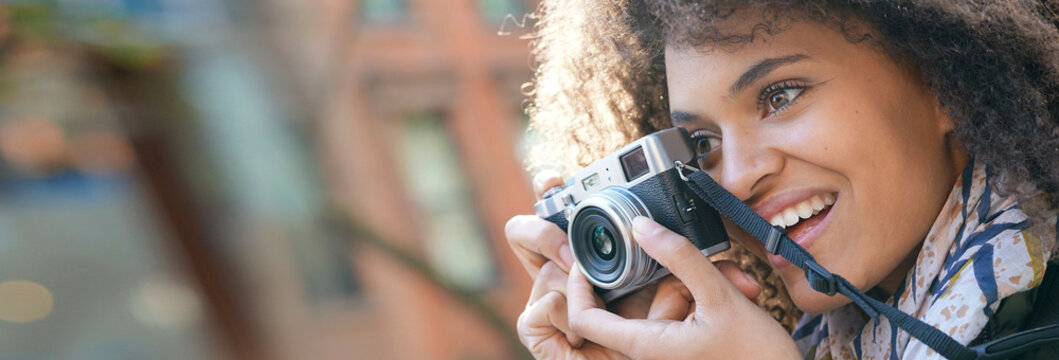 Trendy girl in New York City taking pictures with camera