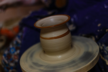 Clay potter creating on the pottery wheel