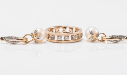Elegant gold earrings with pearls and a chunky ring with small d