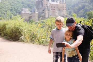 Portrait of father with two kids outdoors