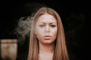 Attractive young girl smoking a cigar