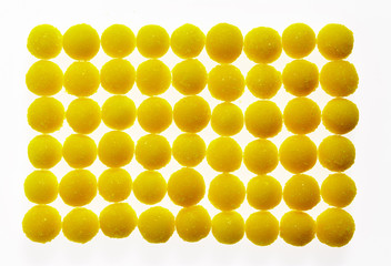 Round lemon candies on a white background.