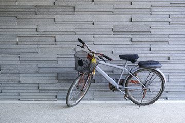 bicycle leaning against stone wall