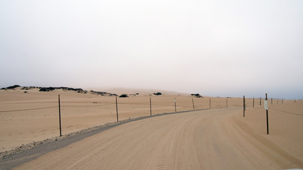 Guadalupe-Nipomo, CALIFORNIA, UNITED STATES - OCT 8, 2014: sand dunes and a street within the National Park in CA along Highway No 1, USA