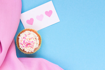 Valentine's Day background. Valentine's day card and cupcake with copy space on the blue background