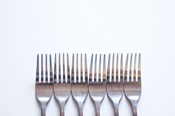 Silver fork neatly on a white table