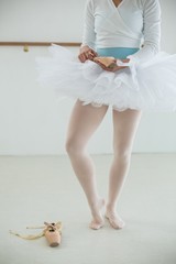 Ballerina holding ballet shoes