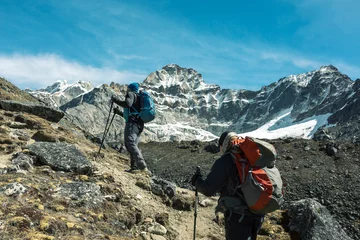 Foto op Plexiglas Mountain Climbers walking up on rocky Foot © alexbrylovhk