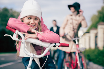 Cute little girl sitting on bicycle