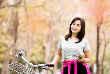 woman posing with phone and bicycle